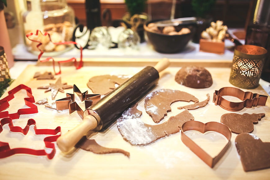 Gingerbread cookie dough with rolling pin and cutters