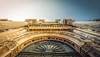 Low angle view of ornate classical architecture with columns and arch