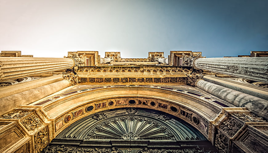 Low angle view of ornate classical architecture with columns and arch