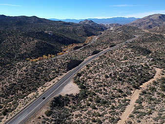 Aerial view of winding desert highway through mountains