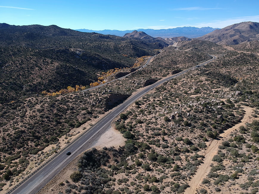 Aerial view of winding desert highway through mountains