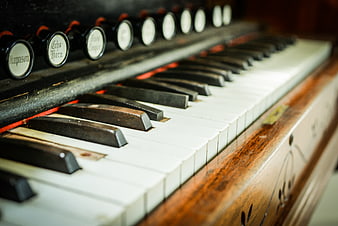 Close-up of vintage organ keys and stop knobs