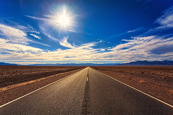 Endless Desert Highway Under Bright Blue Sky