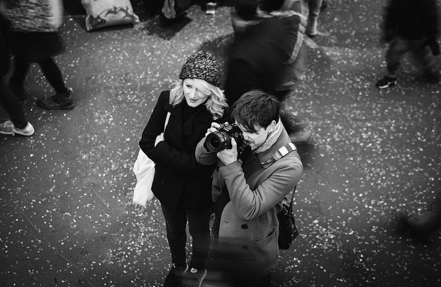 High angle black and white photo of couple looking at camera