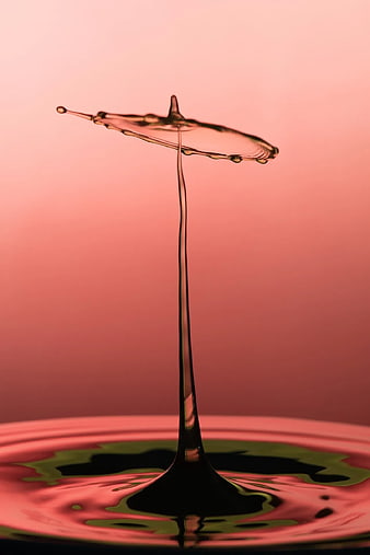 Abstract Water Drop Splash Crown on Pink Background