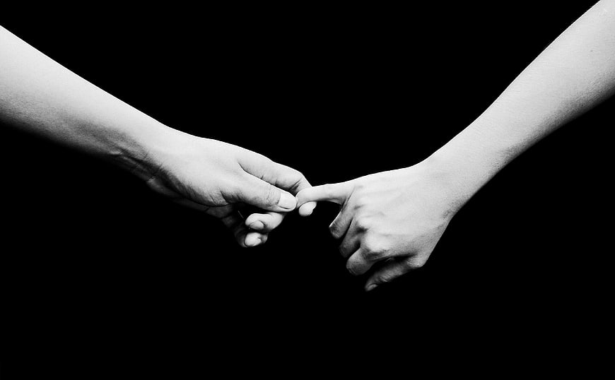 Two Hands Pinky Swearing on Black Background