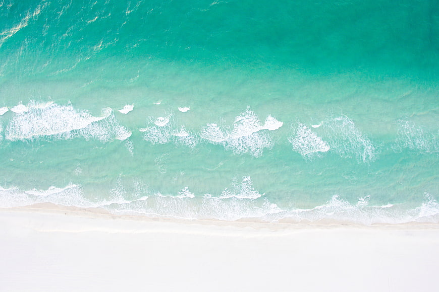 Aerial View of Turquoise Ocean Waves on White Sandy Beach