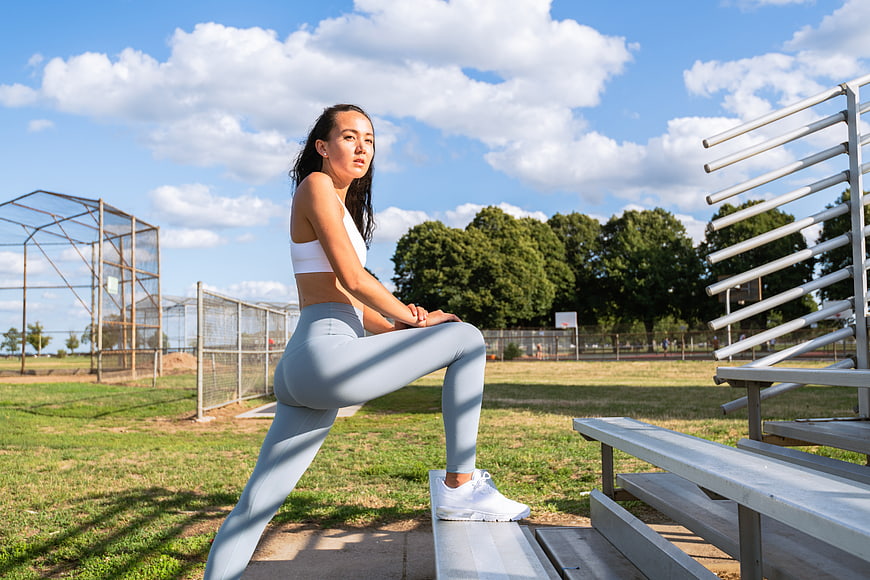 Woman Stretching on Outdoor Gym Equipment