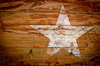 Weathered White Star Painted On Rustic Brown Wooden Planks