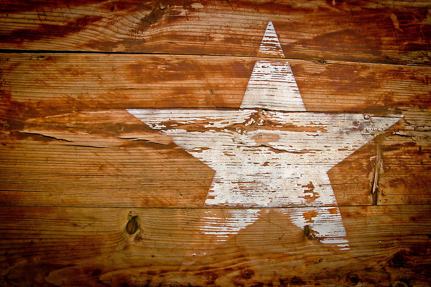 Weathered White Star Painted On Rustic Brown Wooden Planks