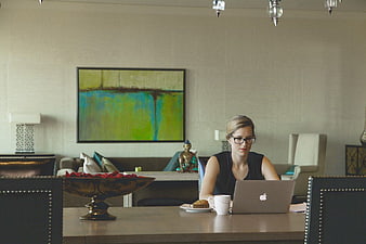 Woman working on laptop in modern office interior