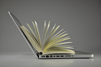 Open book emerging from laptop screen on gray background