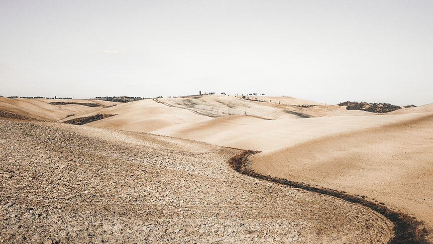 Rolling Arid Hills and Dry Landscape with Sparse Vegetation