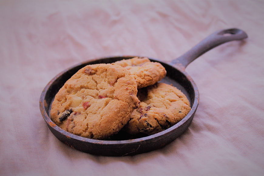 Homemade cookies in a small cast iron skillet on linen