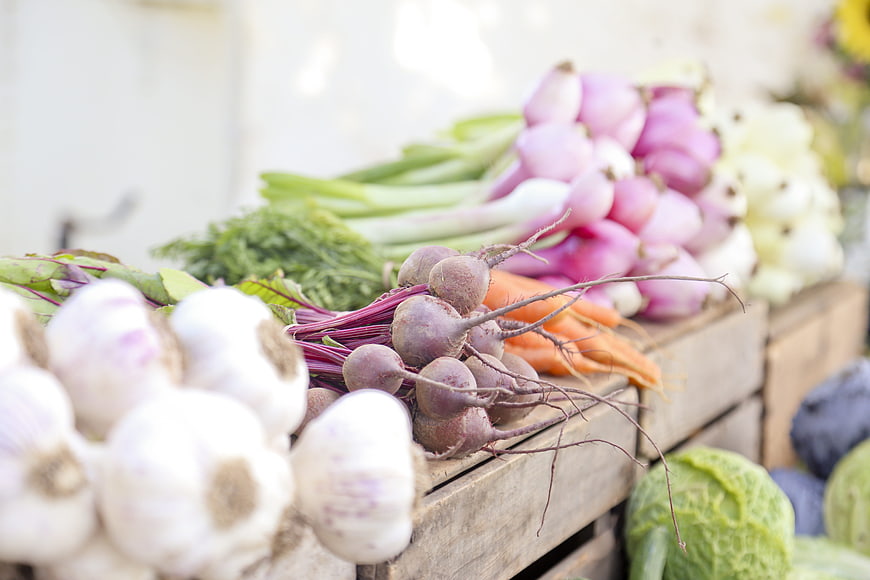 Fresh organic vegetables in wooden crates at a farmers market