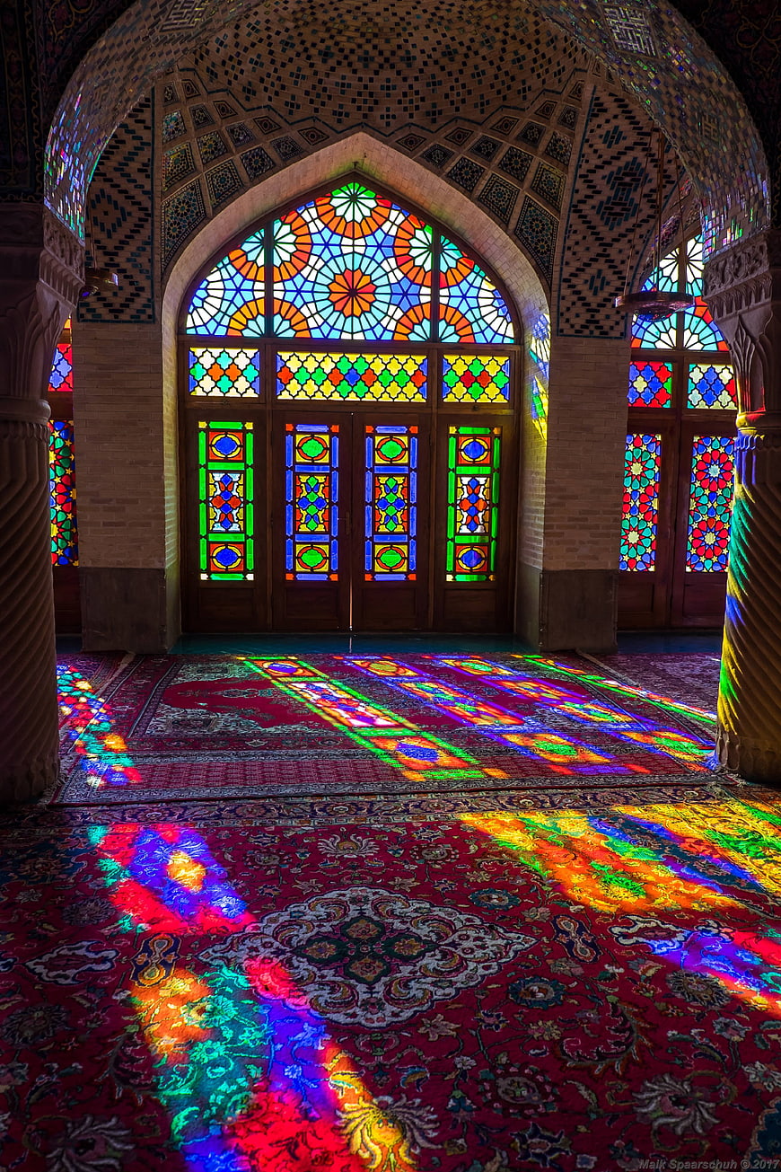 Colorful Stained Glass Light Patterns on Persian Carpet in Nasir al Mulk Mosque