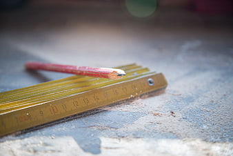 Red Pencil and Metal Rulers on Workbench
