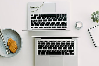 Minimalist Workspace with Two Laptops and Cookies