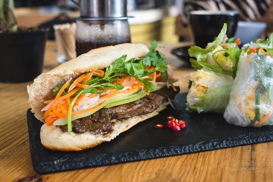 Vietnamese Banh Mi Sandwich and Fresh Spring Rolls on Slate