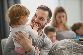 Happy Father Playing with Toddler Daughter at Home