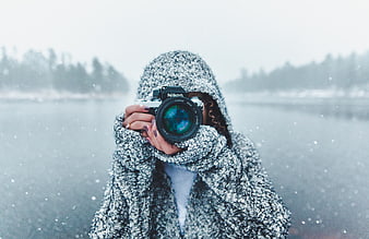 Woman Photographer Taking Photo in Snowy Winter Landscape