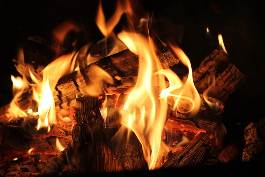 Close-up of burning firewood logs in a fireplace