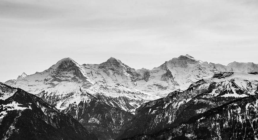 Black and white panoramic view of snow-covered mountain peaks