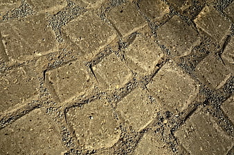 Textured gray stone blocks with gravel gaps background