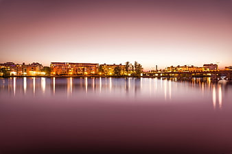 Serene City Skyline at Twilight with Water Reflections