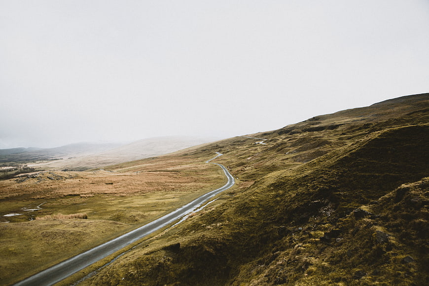 Winding road through misty highland landscape