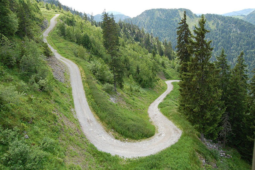 Winding Gravel Road Through Green Mountain Forest