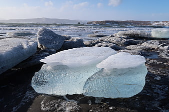 Frozen Ice Blocks on Black Sand Beach in Winter
