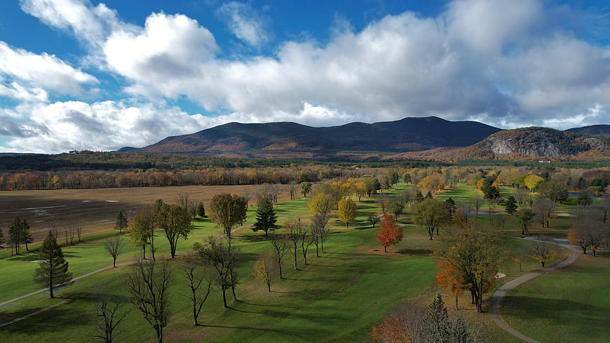 Aerial View of Autumn Park with Mountains and Cloudy Sky
