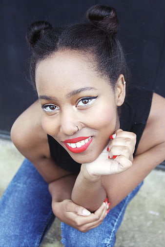 High angle portrait of smiling woman with space buns and red lipstick