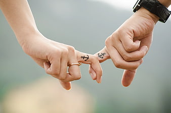 Couple Interlocking Fingers with Matching Anchor Tattoos