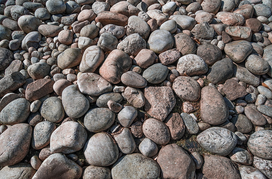 Close-up texture of smooth river stones and pebbles