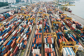 Aerial View of Busy Shipping Port with Containers and Cranes