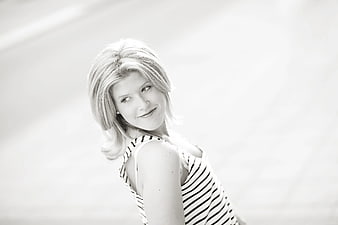 Black and White Portrait of Smiling Blonde Woman in Striped Top