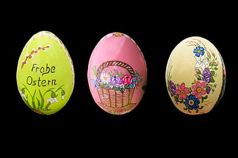 Three Hand-Painted Easter Eggs with Floral Designs on Black