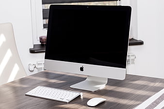 Apple iMac Desktop Computer Setup on Wooden Desk