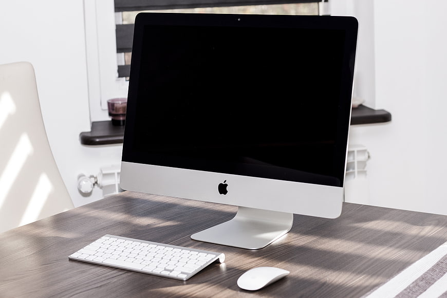 Apple iMac Desktop Computer Setup on Wooden Desk