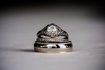 Vintage Diamond Engagement Ring and Wedding Bands on Gray Background