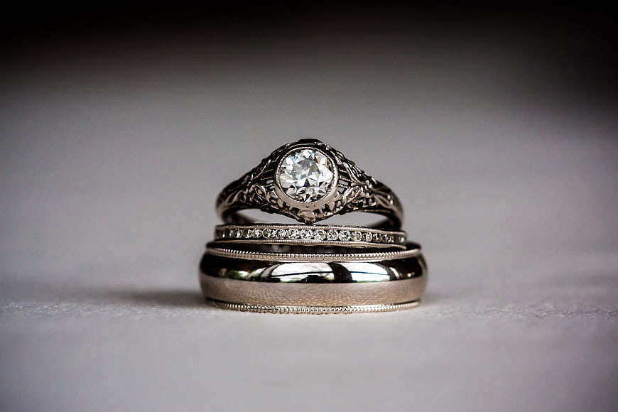 Vintage Diamond Engagement Ring and Wedding Bands on Gray Background