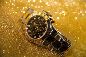 Luxury Gold and Silver Chronograph Watch on Glittering Background