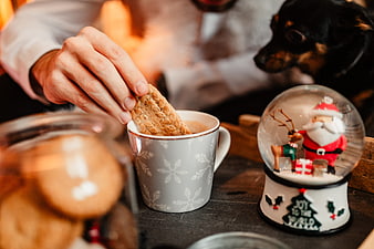 Cozy Christmas hot chocolate with biscuit and snow globe