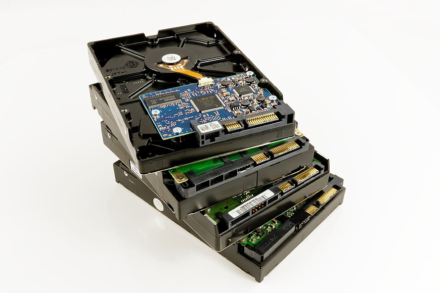 Stack of Open Hard Disk Drives Showing Internal Circuit Boards