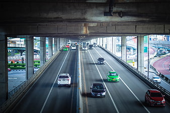 Highway Traffic Under Concrete Overpass in City
