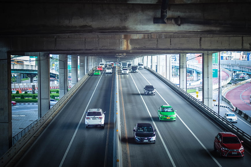 Highway Traffic Under Concrete Overpass in City