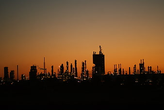 Silhouette of industrial refinery at sunset