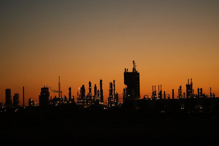 Silhouette of industrial refinery at sunset